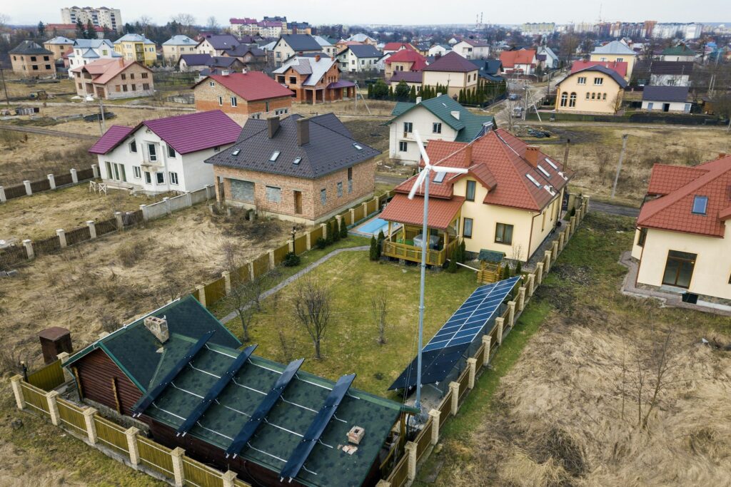 Aerial top view of residential area with new houses with roof solar photo voltaic panels