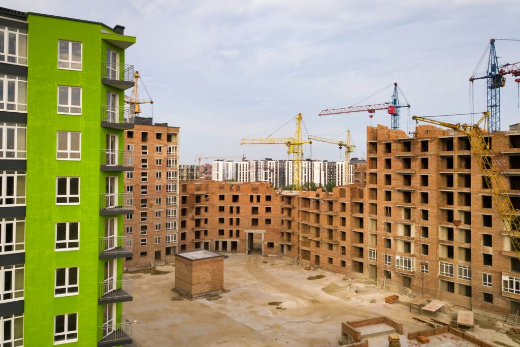 Aerial view of city residential area with high apartment buildings under construction