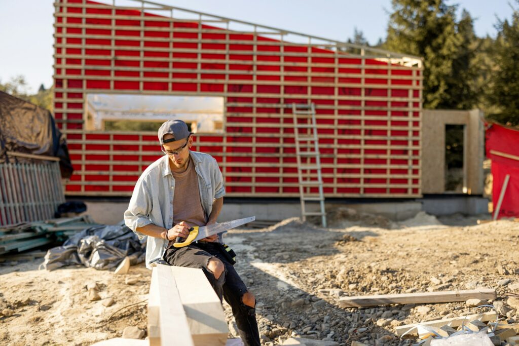 Carpenter works on a construction site outdoors